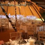 Tents set up in the Tipis with ivy up the poles and chiavari chairs